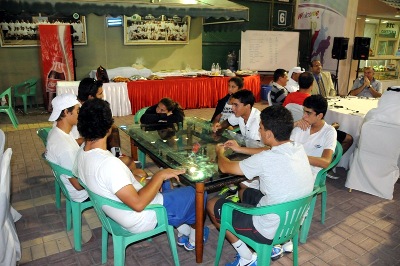 Tennis players relaxing around a table