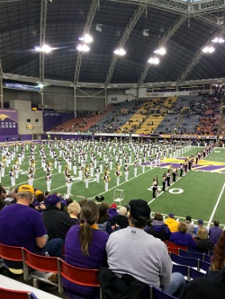 Spectators watching cheerleaders in an indoor stadium