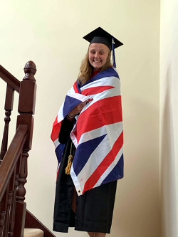 Female graduate on stairs