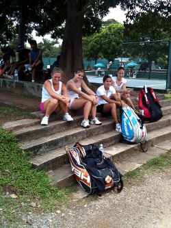 Tennis players sitting on steps