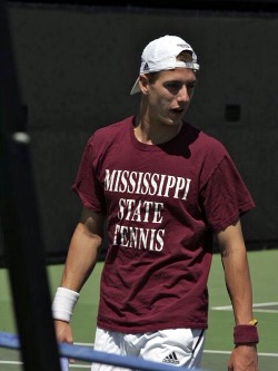 Male tennis player in back-to-front baseball cap